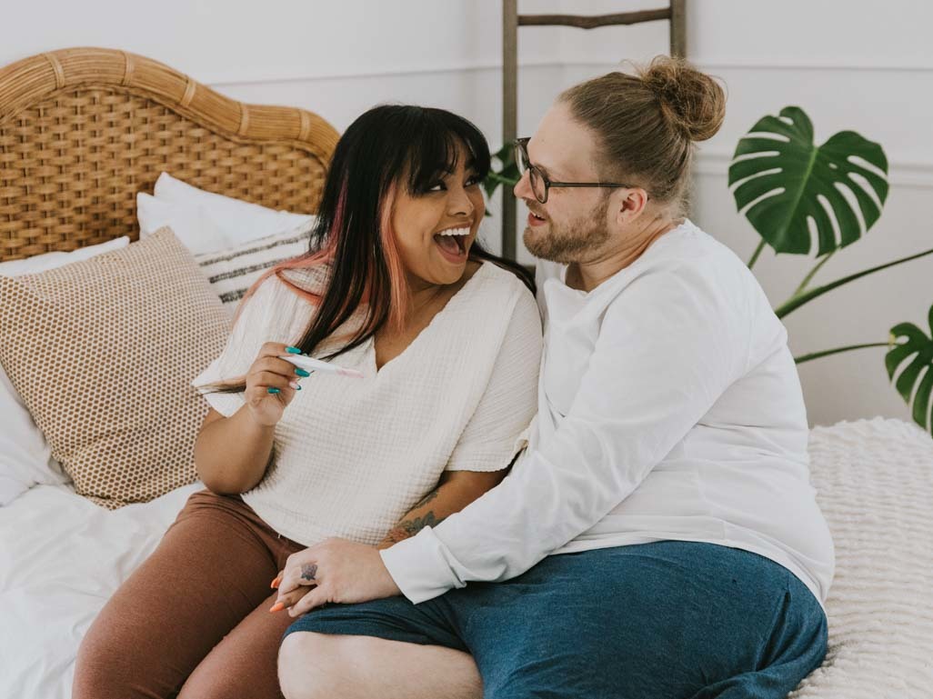 woman holding a positive pregnancy test