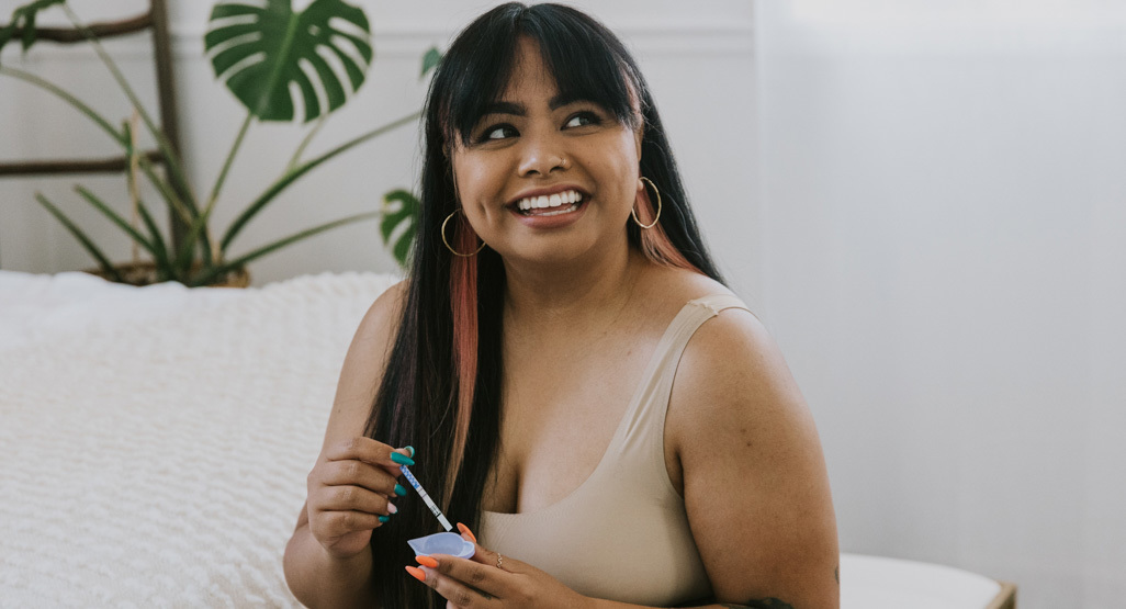 happy woman using an ovulation test kit