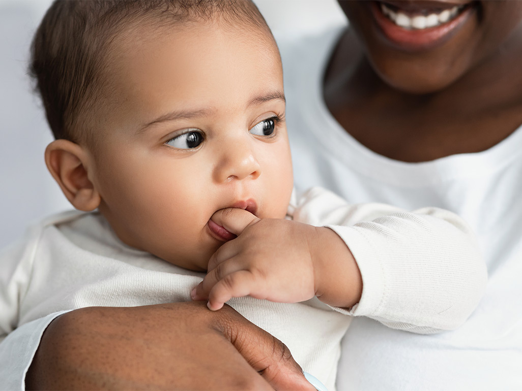 Mom hugging her teething baby 