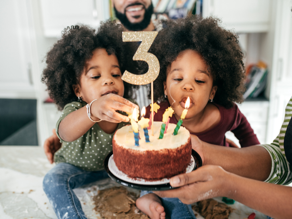 twins blowing out birthday candles