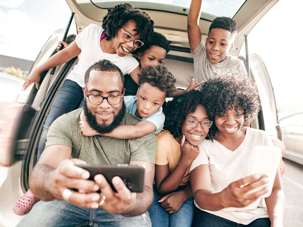 family taking selfie on road trip