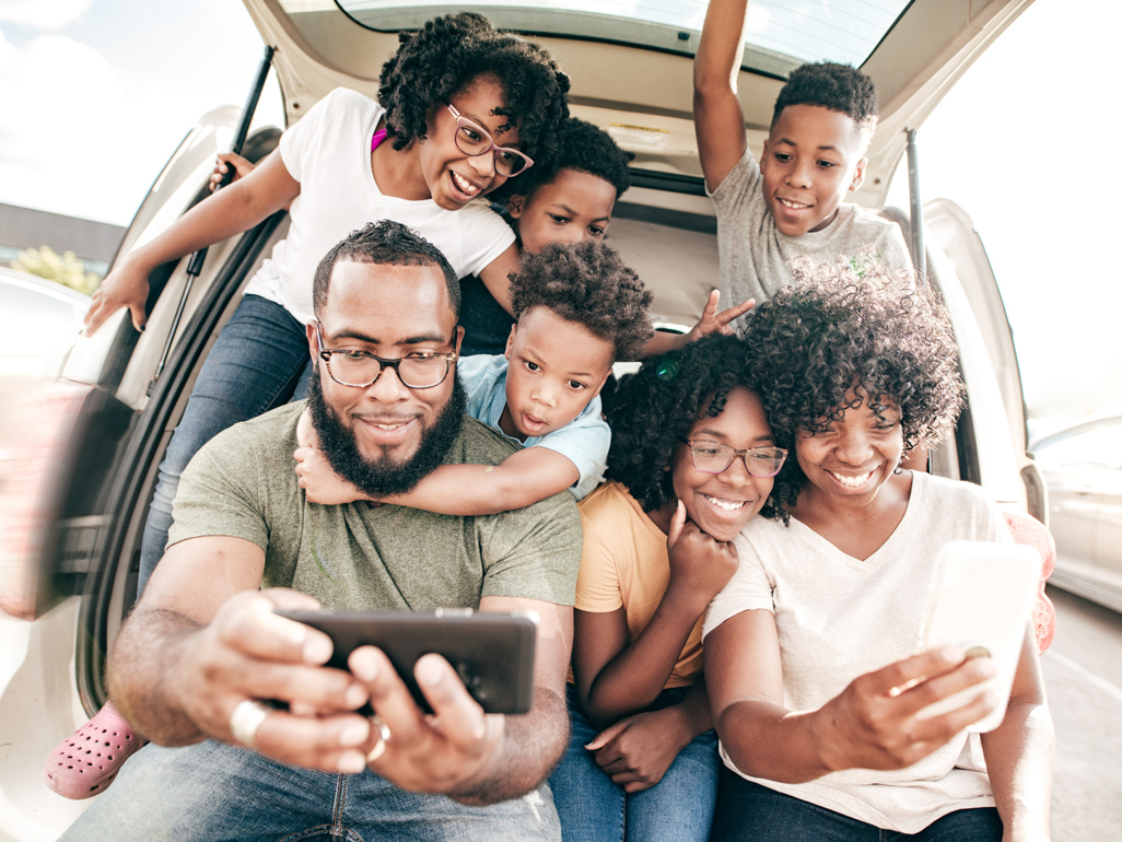 family taking selfie on road trip