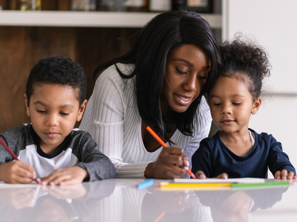 mother helping her children with school work