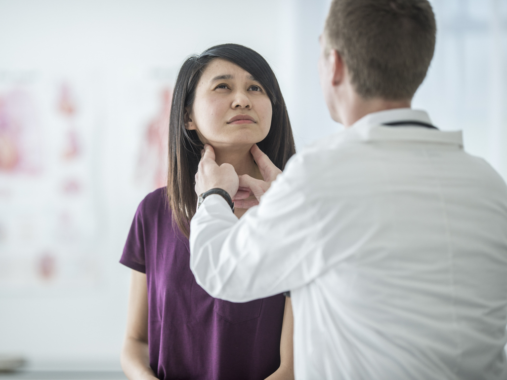 doctor examining woman's glands