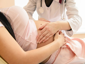 doctor examining pregnant woman