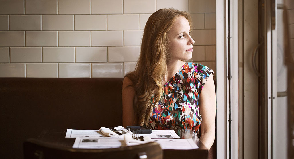 pensive woman looking out the window