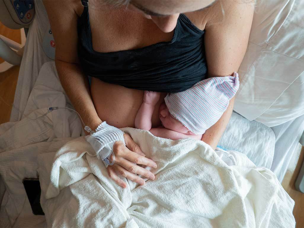 postpartum woman with baby