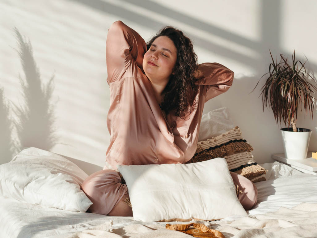 woman feeling relaxed after long night sleep