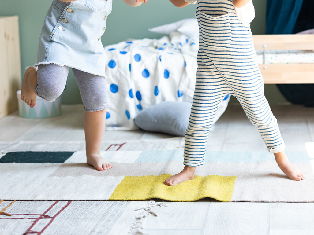 two toddlers dancing inside